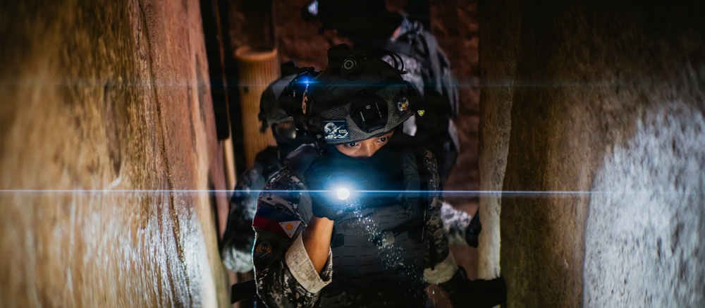 Multinational EOD technicians participate in an IED response drill