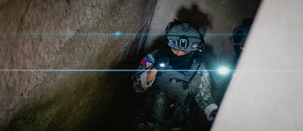 Multinational EOD technicians participate in an IED response drill