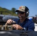U.S. Navy MNC Matthew Dowlen conducts communications test with the Tactical Operations Center during Seabreeze26