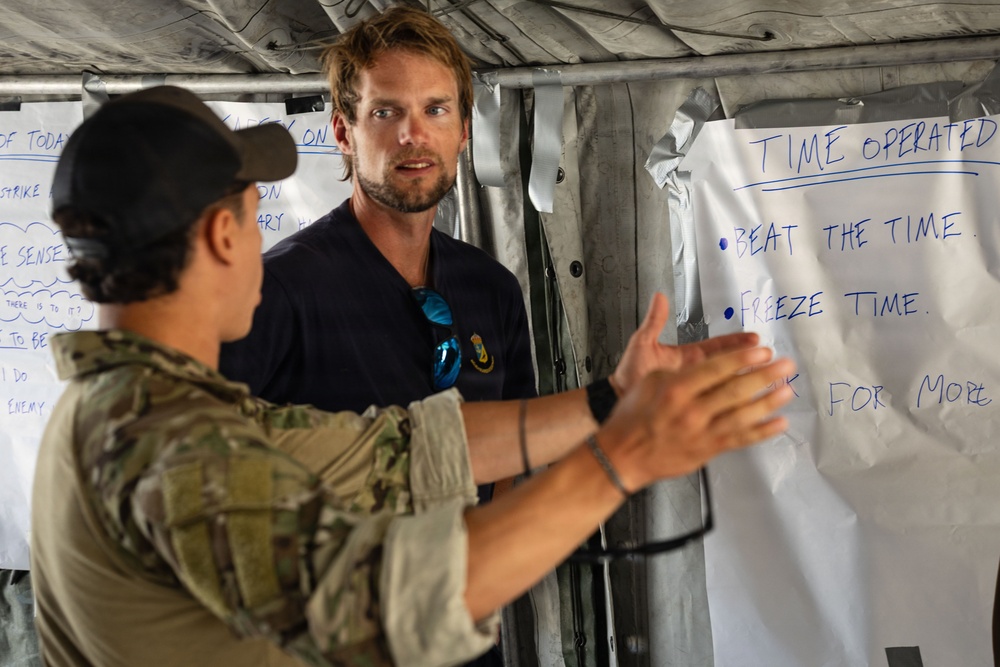 U.S. Navy and Swedish EOD members discuss mine clearance safety during Seabreeze26