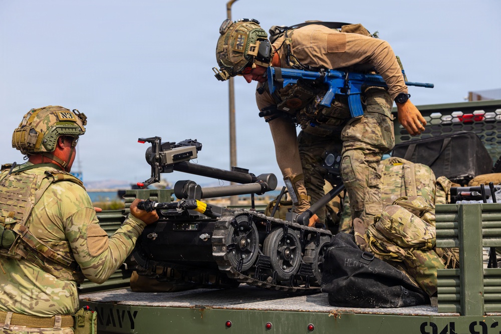 U.S. Navy EODMU 8 member load the Manned Transport Robot System (MTRS) during Seabreeze26
