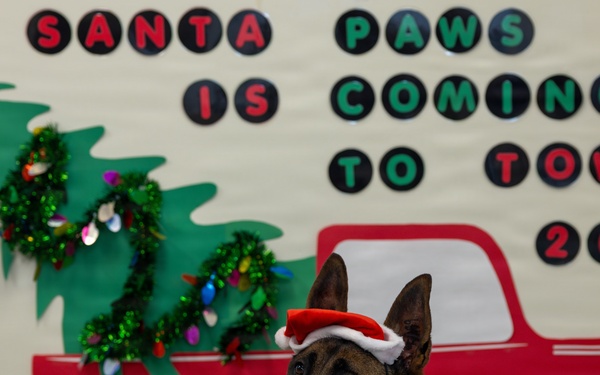 Military Working Dogs from Tinker Air Force Base and two Transportation Security Administration dress as "Santa Paws"