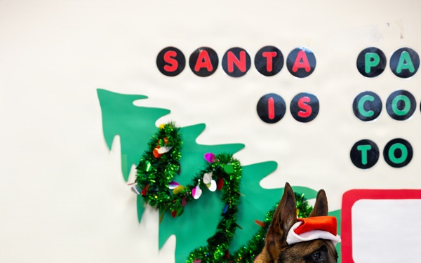 Military Working Dogs from Tinker Air Force Base and two Transportation Security Administration dress as "Santa Paws"