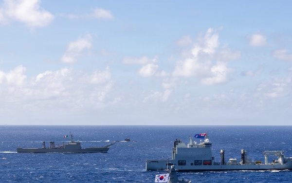 Multinational ships sail in formation during RIMPAC 2026