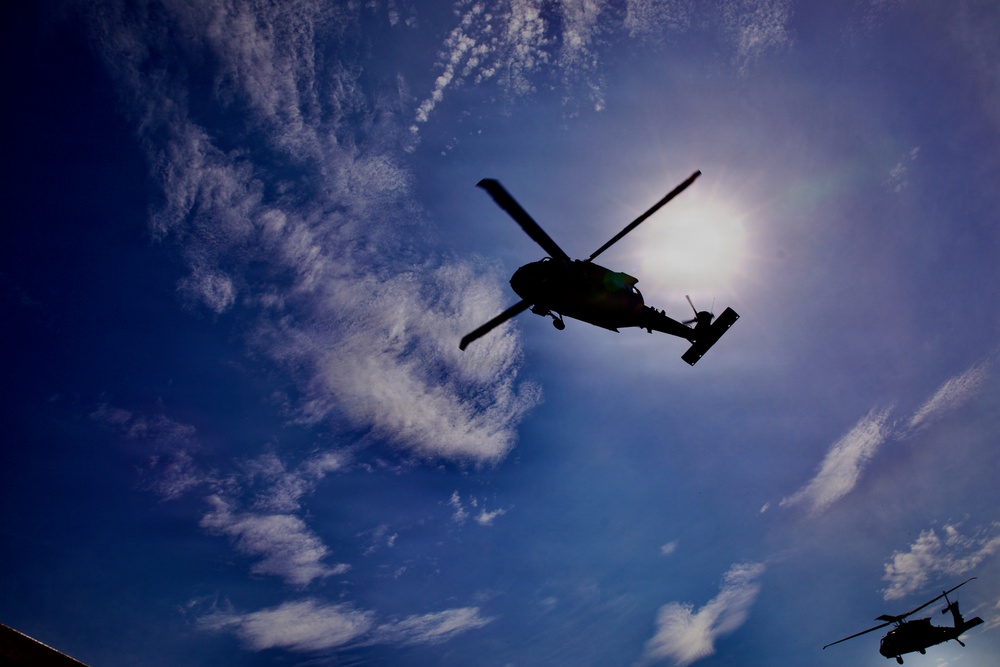 U.S. Army and Malaysian troops coordinate a simulated air-to-ground assault