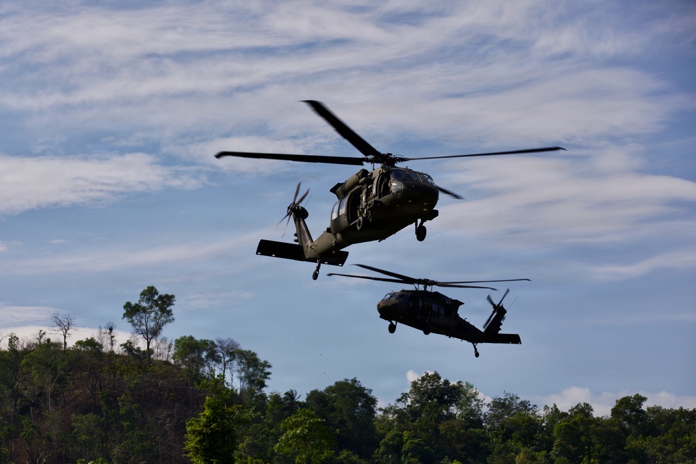 U.S. Army and Malaysian troops coordinate a simulated air-to-ground assault