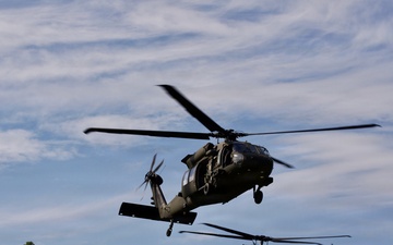 U.S. Army and Malaysian troops coordinate a simulated air-to-ground assault