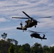 U.S. Army and Malaysian troops coordinate a simulated air-to-ground assault