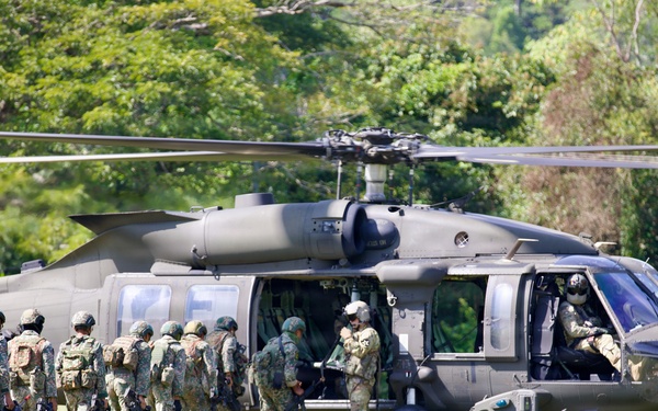 U.S. Army and Malaysian troops coordinate a simulated air-to-ground assault