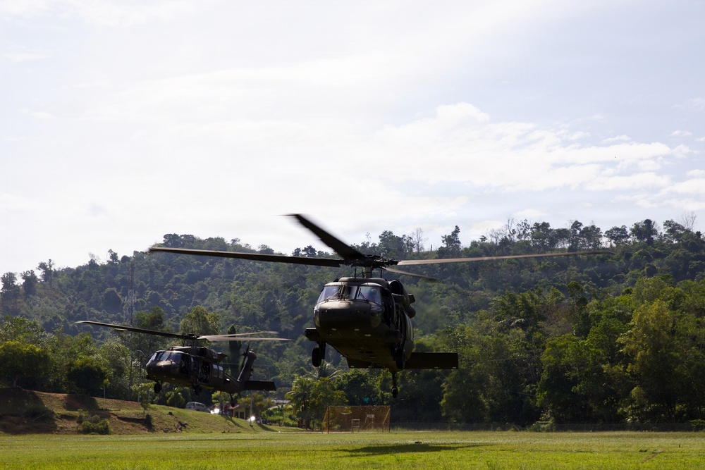 U.S. Army and Malaysian troops coordinate a simulated air-to-ground assault
