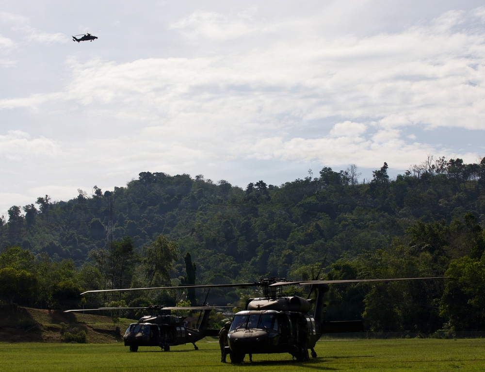 U.S. Army and Malaysian troops coordinate a simulated air-to-ground assault