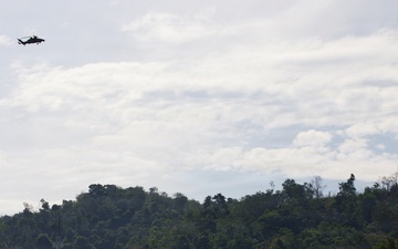 U.S. Army and Malaysian troops coordinate a simulated air-to-ground assault