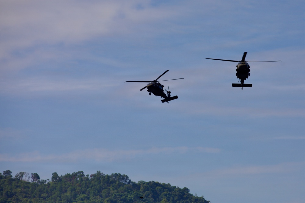 U.S. Army and Malaysian troops coordinate a simulated air-to-ground assault