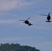 U.S. Army and Malaysian troops coordinate a simulated air-to-ground assault