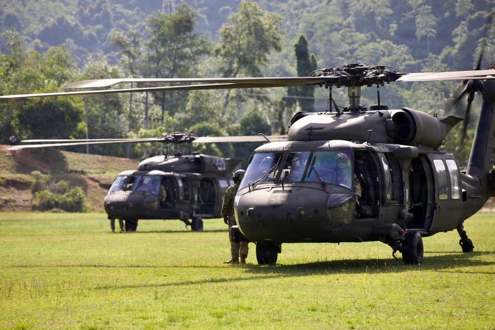 U.S. Army and Malaysian troops coordinate a simulated air-to-ground assault