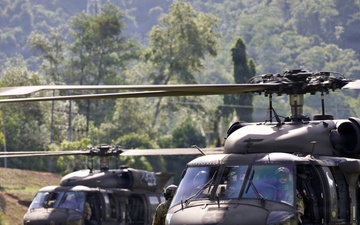 U.S. Army and Malaysian troops coordinate a simulated air-to-ground assault