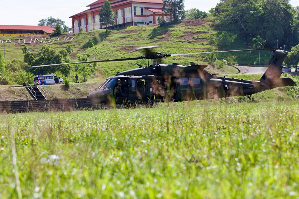 U.S. Army and Malaysian troops coordinate a simulated air-to-ground assault