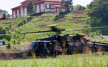 U.S. Army and Malaysian troops coordinate a simulated air-to-ground assault