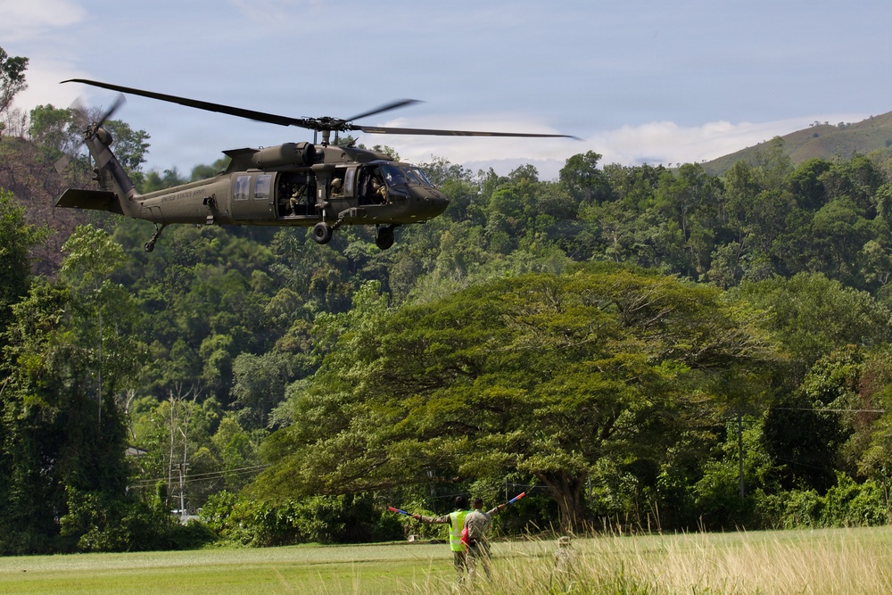 U.S. Army and Malaysian troops coordinate a simulated air-to-ground assault