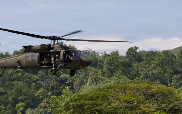 U.S. Army and Malaysian troops coordinate a simulated air-to-ground assault
