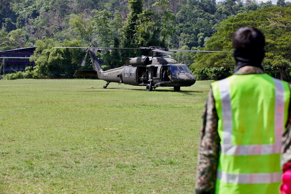 U.S. Army and Malaysian troops coordinate a simulated air-to-ground assault