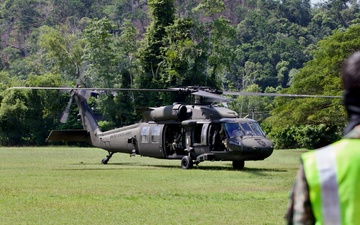 U.S. Army and Malaysian troops coordinate a simulated air-to-ground assault
