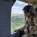 Crew Chiefr Visually Inspects Black Hawk in Flight