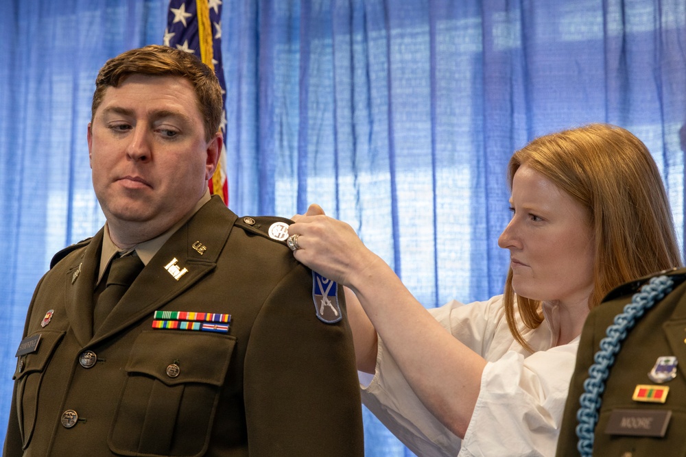 U.S. Army Lt. Col. Travis Moore promotes Capt. Matthew Standridge to the rank of major