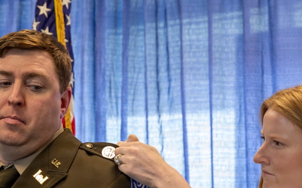 U.S. Army Lt. Col. Travis Moore promotes Capt. Matthew Standridge to the rank of major