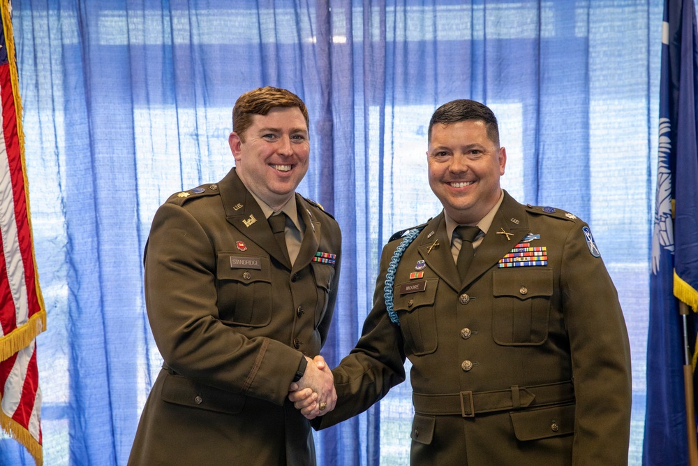 U.S. Army Lt. Col. Travis Moore promotes Capt. Matthew Standridge to the rank of major