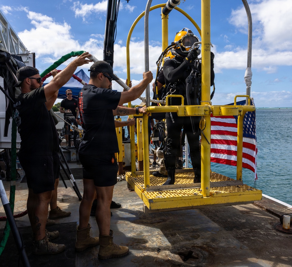 U.S. Navy Divers prepare to enter water for salvage dive during RIMPAC 2026
