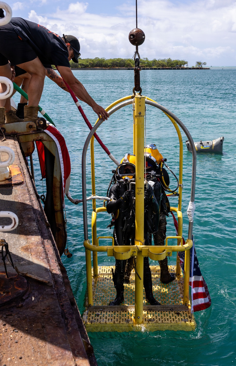 U.S. Navy Divers resurface following a salvage dive during RIMPAC 2026