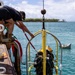 U.S. Navy Divers resurface following a salvage dive during RIMPAC 2026