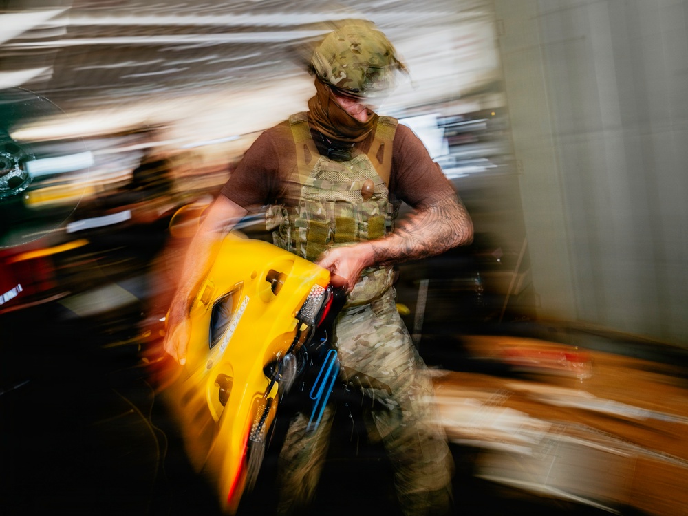 Navy Divers and EOD Technicians Conduct a Shipboard Response Drill