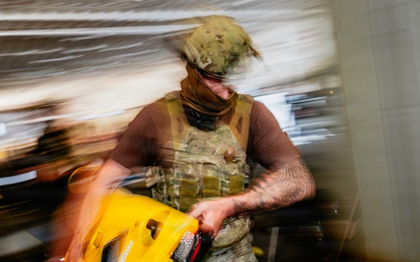 Navy Divers and EOD Technicians Conduct a Shipboard Response Drill