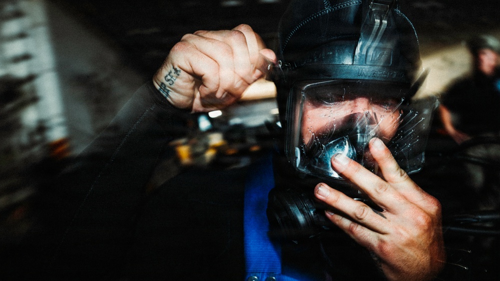 Navy Divers and EOD Technicians Conduct a Shipboard Response Drill