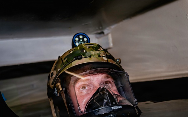Navy Divers and EOD Technicians Conduct a Shipboard Response Drill