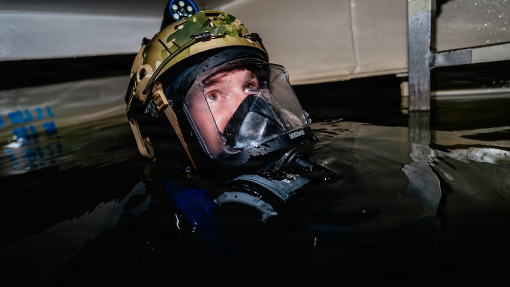 Navy Divers and EOD Technicians Conduct a Shipboard Response Drill