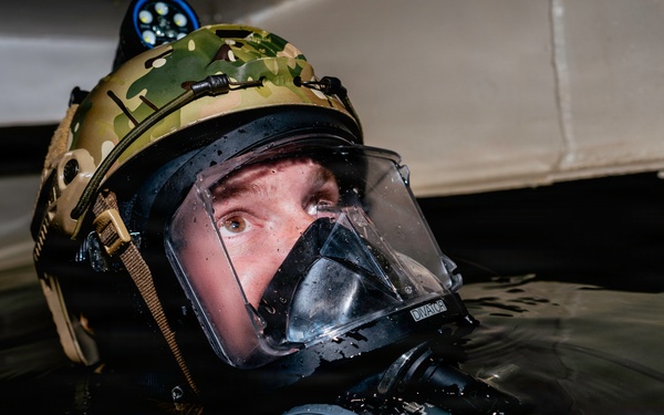 Navy Divers and EOD Technicians Conduct a Shipboard Response Drill