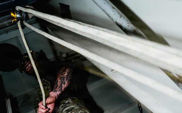 Navy Divers and EOD Technicians Conduct a Shipboard Response Drill