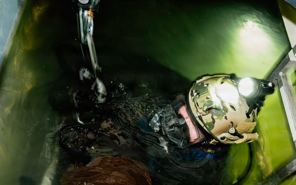Navy Divers and EOD Technicians Conduct a Shipboard Response Drill