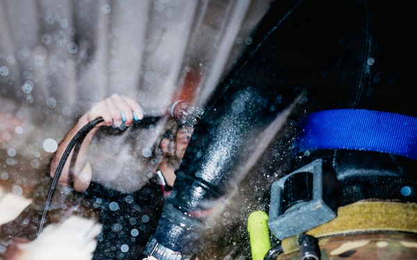 Navy Divers and EOD Technicians Conduct a Shipboard Response Drill