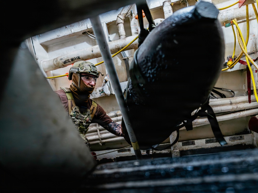 Navy Divers and EOD Technicians Conduct a Shipboard Response Drill