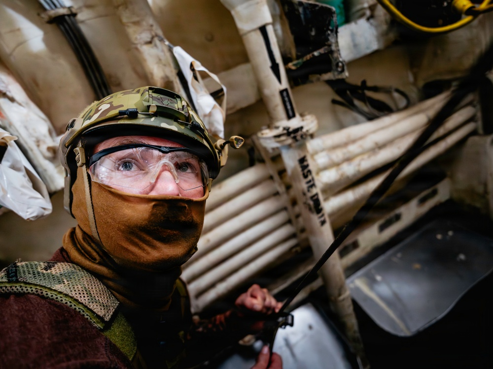 Navy Divers and EOD Technicians Conduct a Shipboard Response Drill