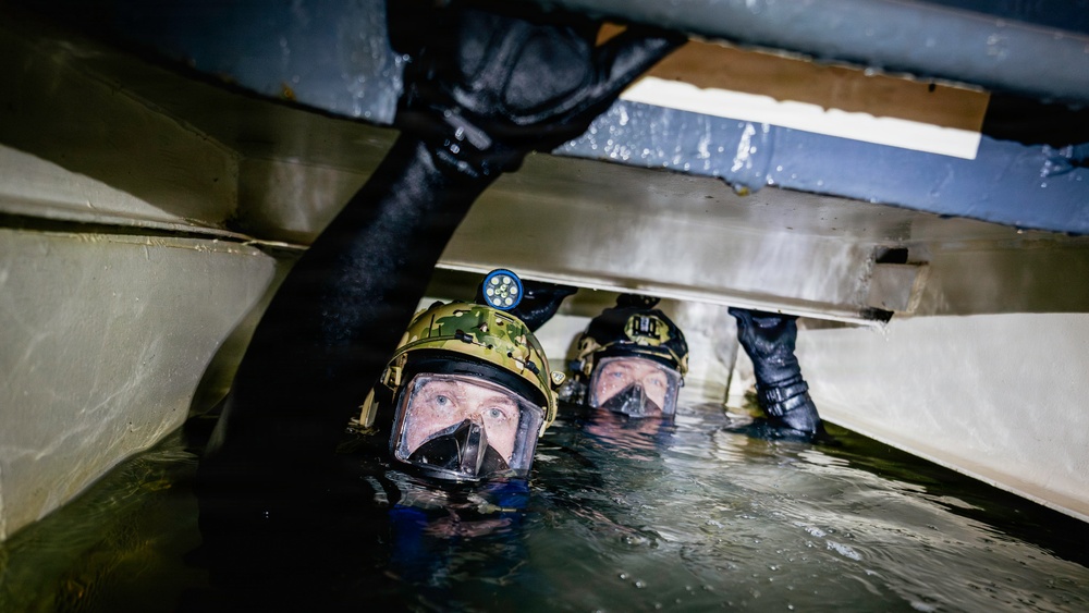 Navy Divers and EOD Technicians Conduct a Shipboard Response Drill
