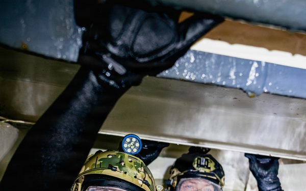 Navy Divers and EOD Technicians Conduct a Shipboard Response Drill