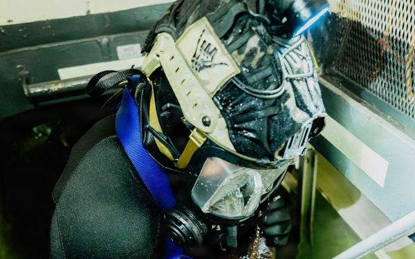 Navy Divers and EOD Technicians Conduct a Shipboard Response Drill