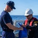 USCGC Kimball (WMSL 756) commanding officer speaks with Philippine coast guardsmen