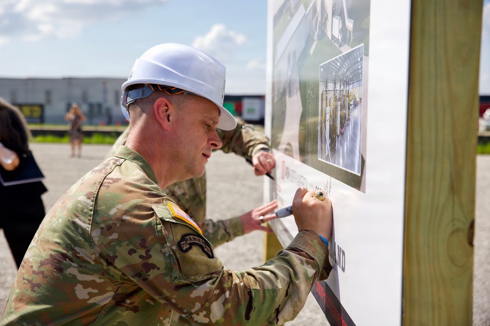 MG Schneider, Commander, PAE A&amp;A sign the future artillery complex sign for the groundbreaking ceremony at the U.S. Army Iowa Army Ammunition Plant.