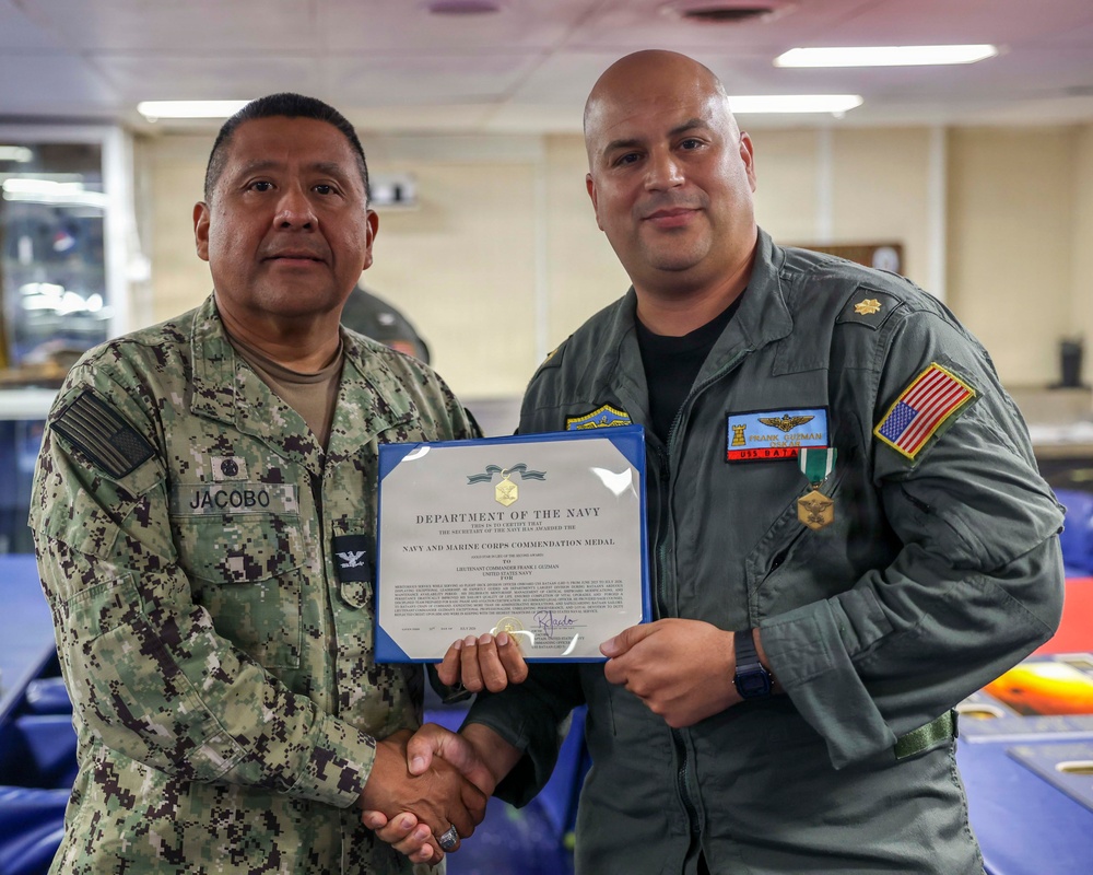 Lt. Cmdr. Guzman Receives Award and Rung Off